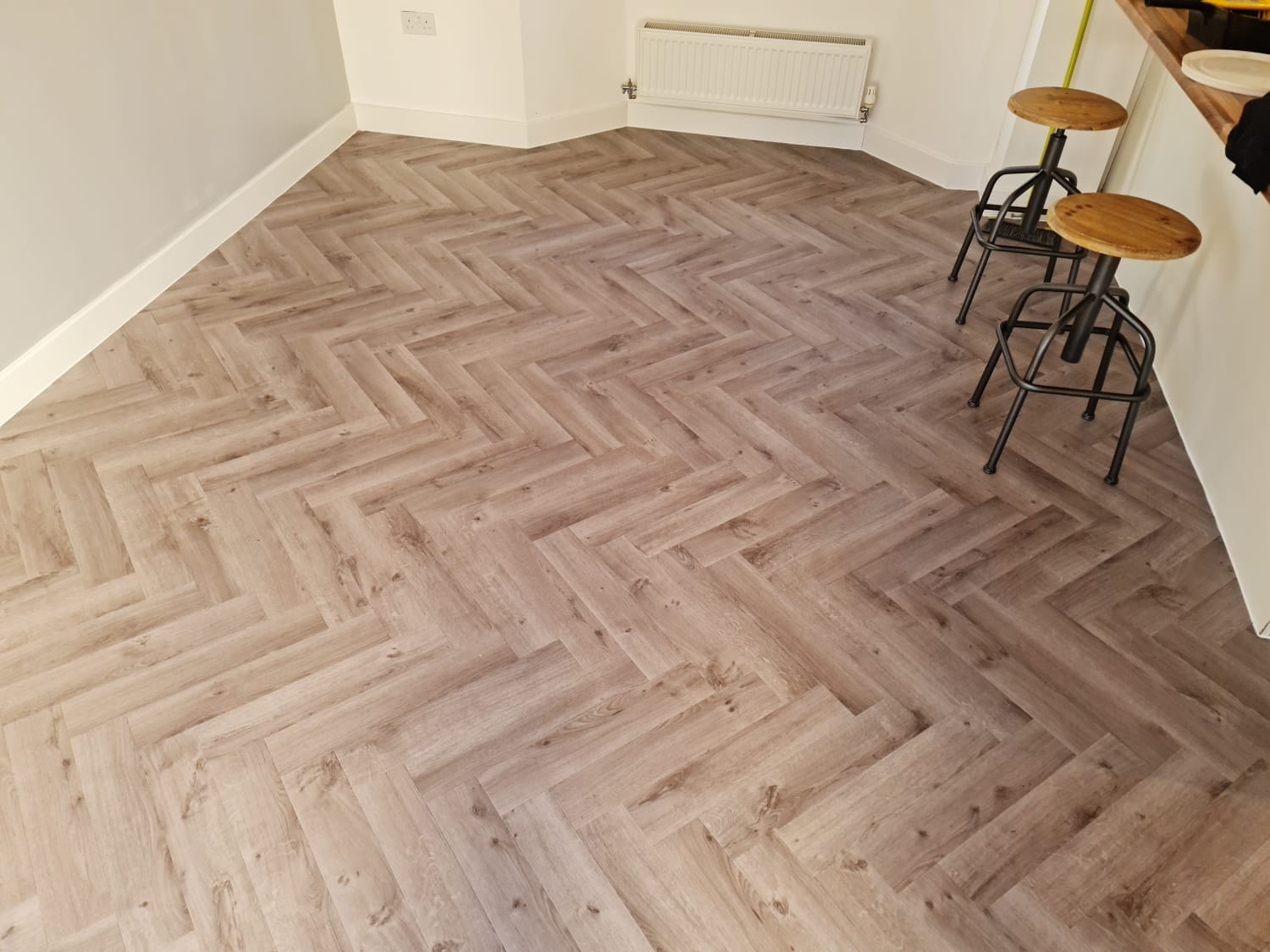 Herringbone LVT flooring installed in a Marlborough living space by Avana Flooring