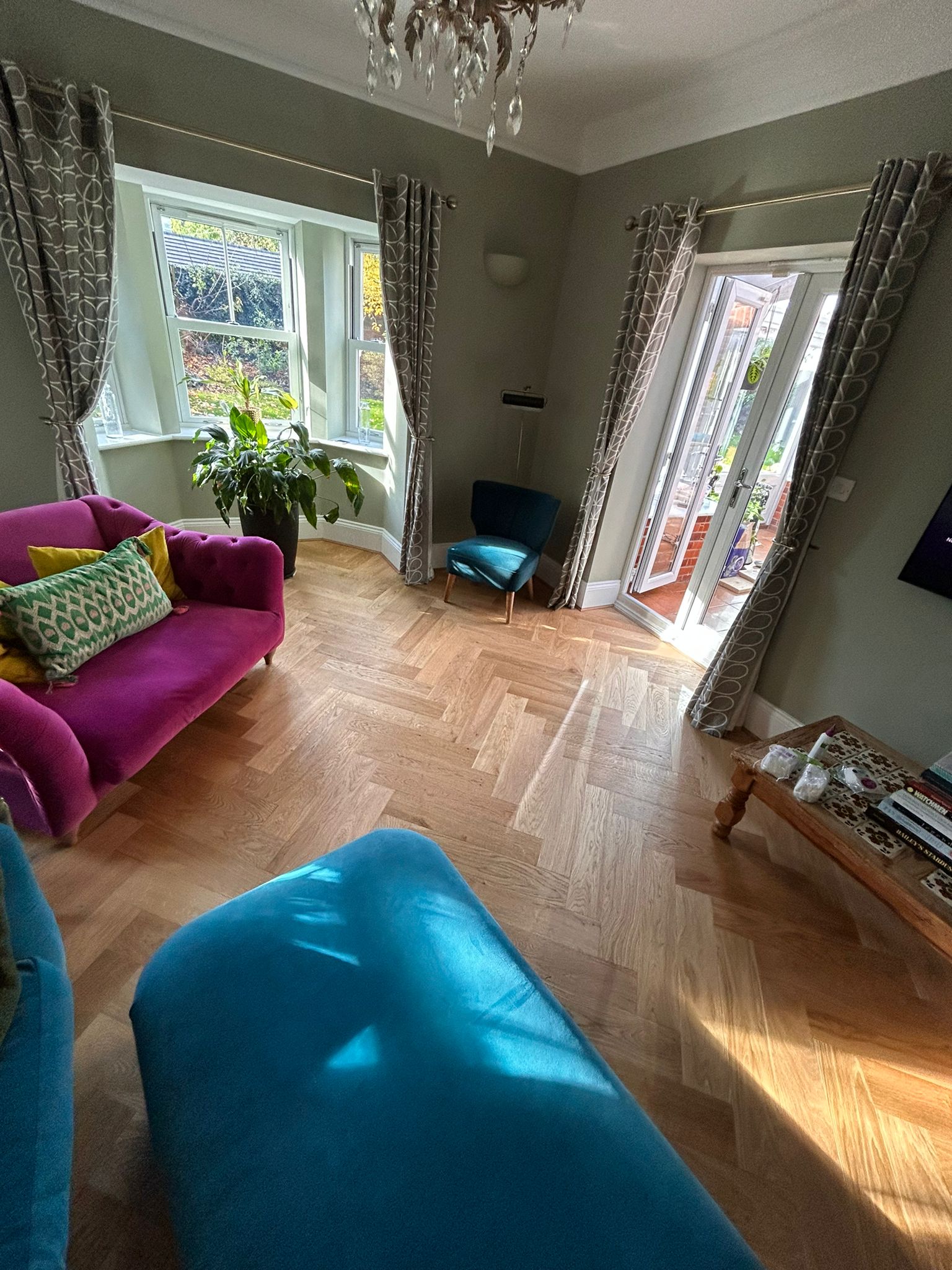 Light oak herringbone engineered wood flooring installed in a bright Marlborough living room